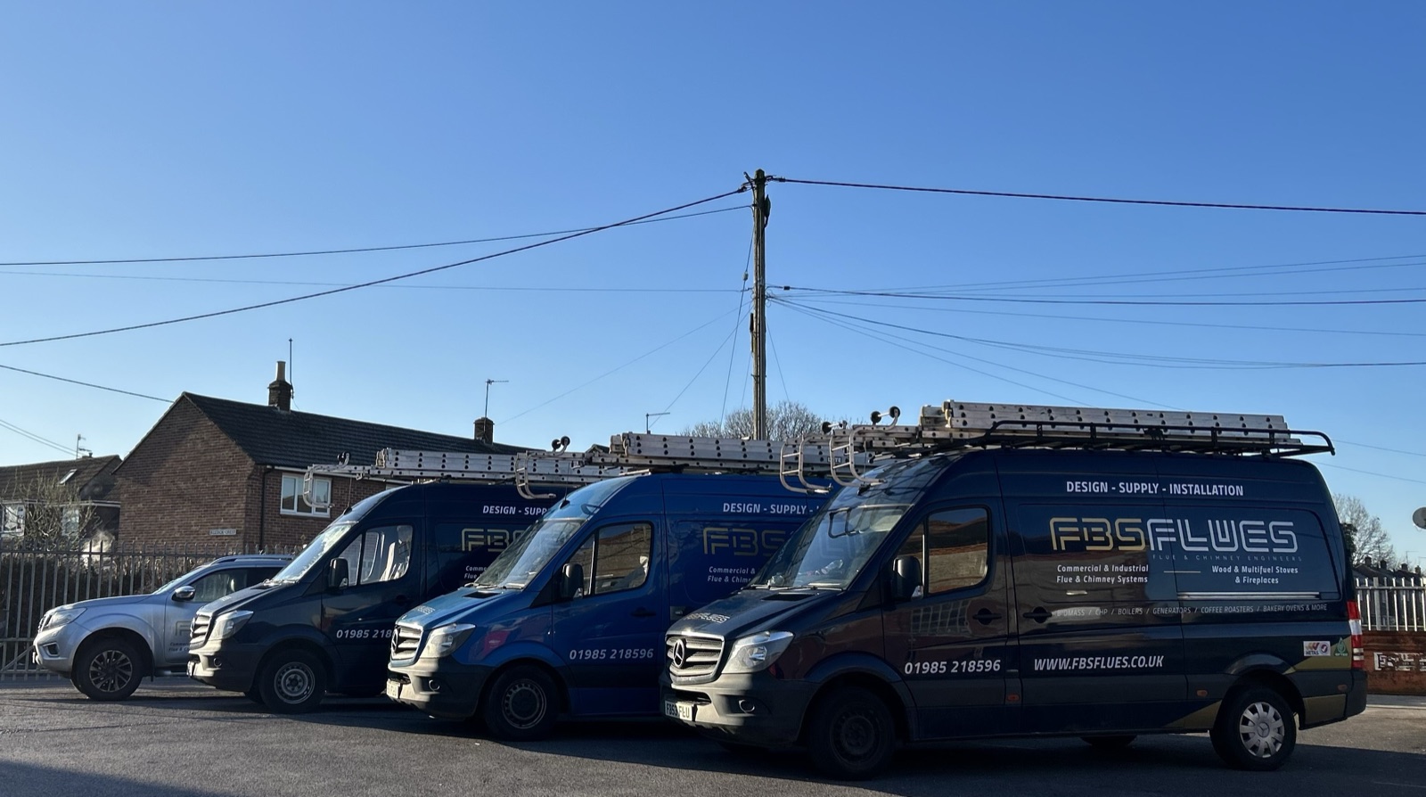 FBS Flues branded van fleet lined up on site