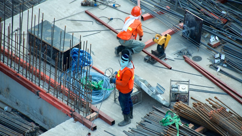 Engineer surveying a chimney with measuring equipment